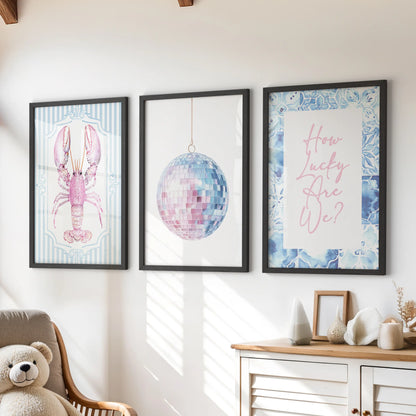 Above the playroom dresser, three disco mirror ball prints in black frames bring a lively, beach-bright sparkle to the kids’ space.