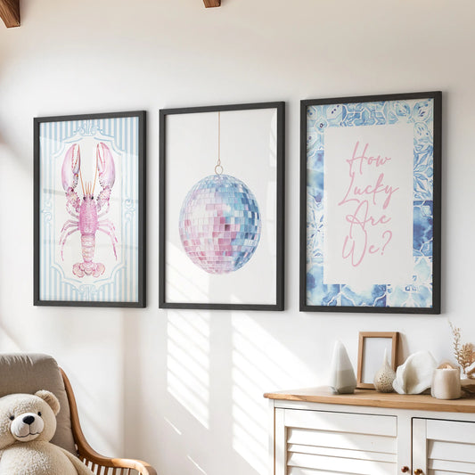 Above the playroom dresser, three disco mirror ball prints in black frames bring a lively, beach-bright sparkle to the kids’ space.