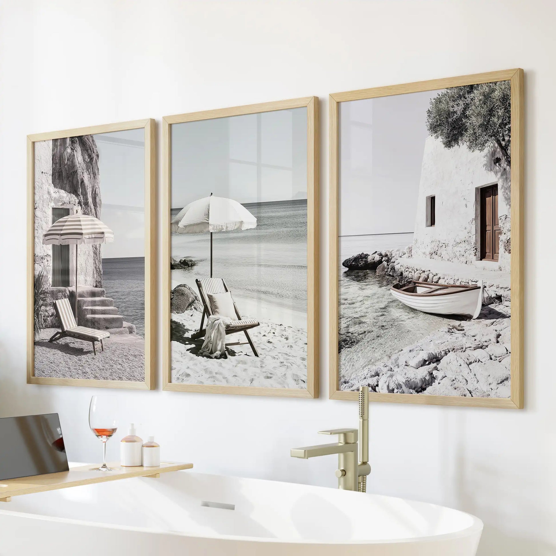 Aegean seaside vistas, a 3-print gallery wall in thin wood frames, set over the freestanding tub to bring spa-calm energy to the bathroom.