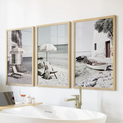 Aegean seaside vistas, a 3-print gallery wall in thin wood frames, set over the freestanding tub to bring spa-calm energy to the bathroom.