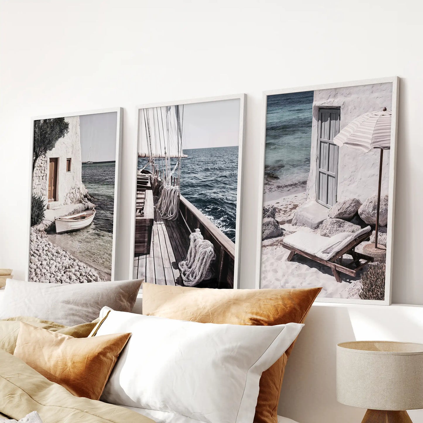 Greek island seascapes 3-piece artwork set in white frames, centered over the bed headboard for a serene, sunlit coastal bedroom statement.