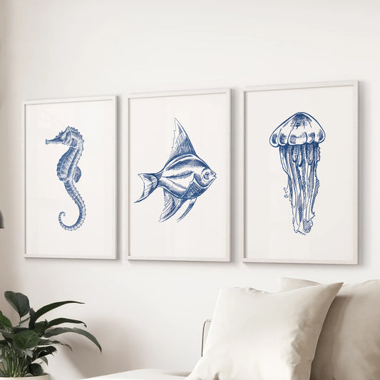 Marine animals set of 3 wall art prints, white-framed, float over the sectional in a living room to create a calm, beach-inspired focal point with soft blues.
