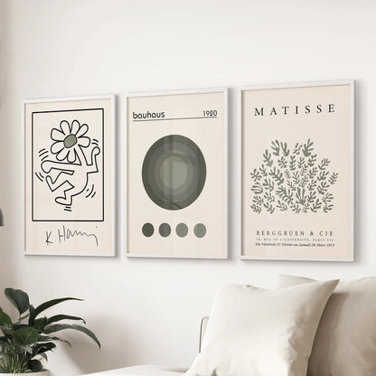Neutral modern wall prints, 3-piece set, ideal for the living room; white-framed and styled to sit behind the couch with soft green, gallery-like balance.