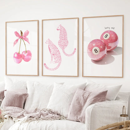 Modern pop-art wall art set of 3 with bold pink designs and playful themes. Thinwood frames over the couch.