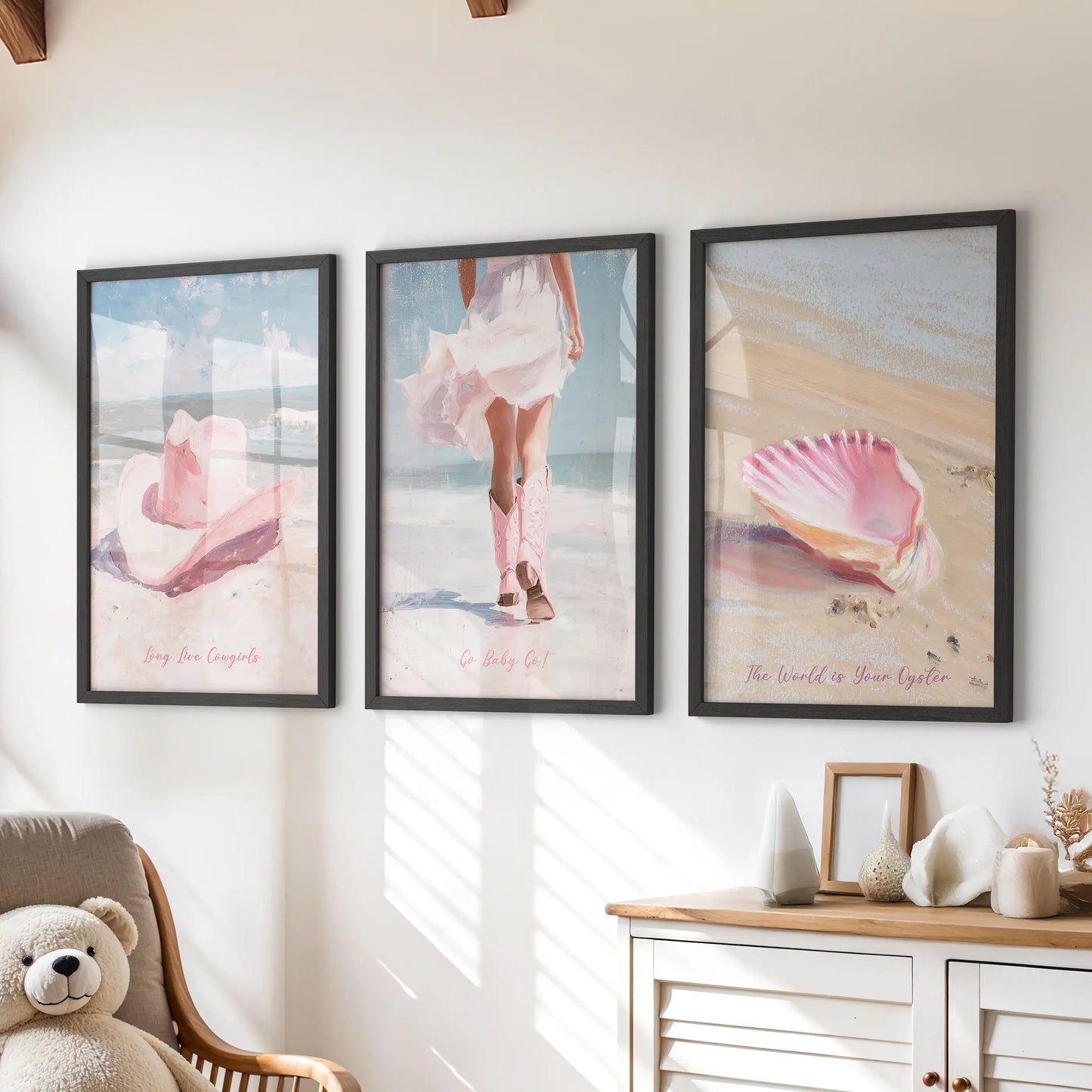 Pink seashells set of three wall art prints in sleek black frames, ideal for a kids room above the chest of drawers, adding breezy seaside color.