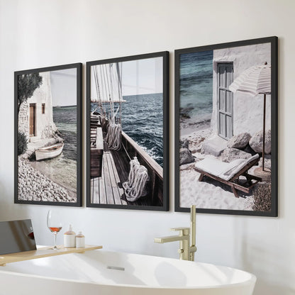 Mediterranean sailboats wall art, a set of three in black frames, placed above the bathtub to bring a breezy coastal lift to a calm bathroom.