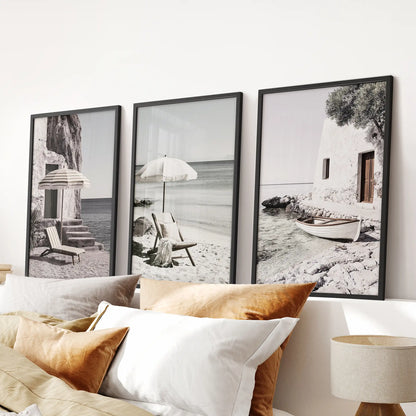 Calm ocean and shoreline scenes, a 3-piece gallery wall in matte black frames, placed over the bed to weave a serene coastal note through the bedroom.
