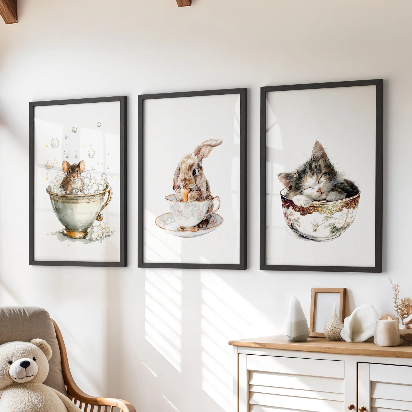 Bunny in a teacup, a set of three art prints in black frames, sits above the playroom chest of drawers for a cozy, storybook gallery wall.