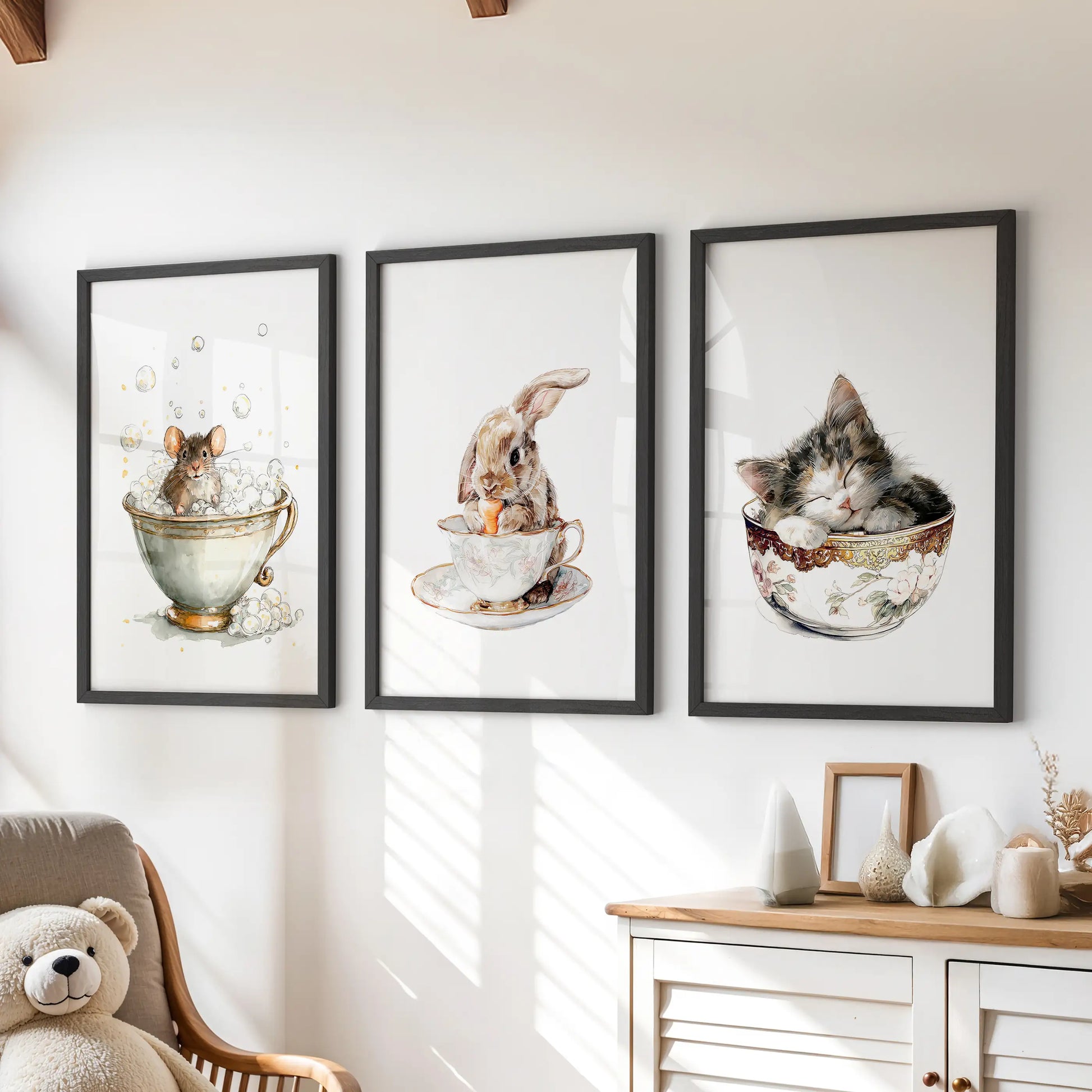 Bunny in a teacup, a set of three art prints in black frames, sits above the playroom chest of drawers for a cozy, storybook gallery wall.