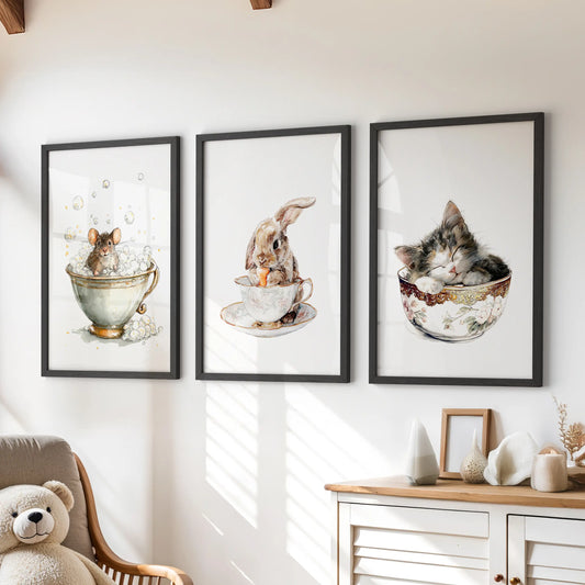 Bunny in a teacup, a set of three art prints in black frames, sits above the playroom chest of drawers for a cozy, storybook gallery wall.