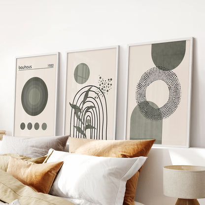 Mid-century modern abstract shapes, set of 3 posters in white frames, align above the bedroom headboard for a calm, neutral green statement.