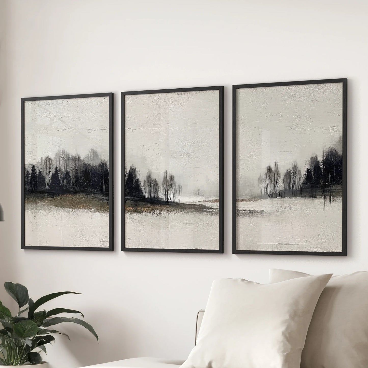 Nordic cabin landscape, three-piece art print set in sleek black frames, arranged in a lounge over a sectional sofa for a minimalist look.