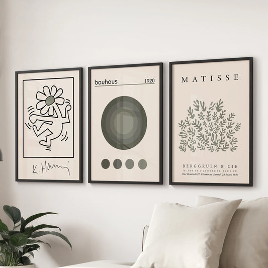 Matisse-inspired cutout prints in a trio, wall art for the sitting room, hung behind the couch in sleek black frames to bring soft green tones.