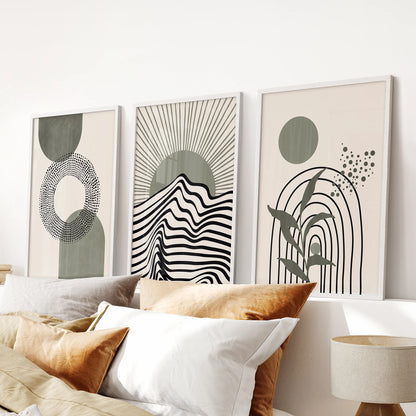 Three minimalist abstract wall prints in sage green rest over the bedroom headboard, their white frames keeping the look calm and pared-back.