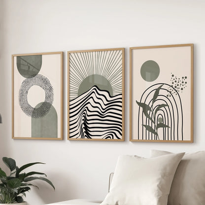 Mid-century geometric shapes 3-print wall art settles behind the sofa in a lounge, shown in warm oak frames to tie together sage accents and neutrals.