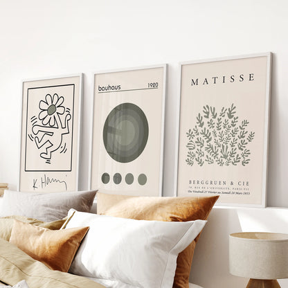 Bauhaus geometric art prints, three-print set, white frames and arranged above the headboard to freshen the bedroom with airy sage and neutrals.