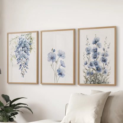 Modern floral prints form a 3-piece gallery wall in light oak frames above the sectional in the sitting room, delivering airy blue botanicals at scale.