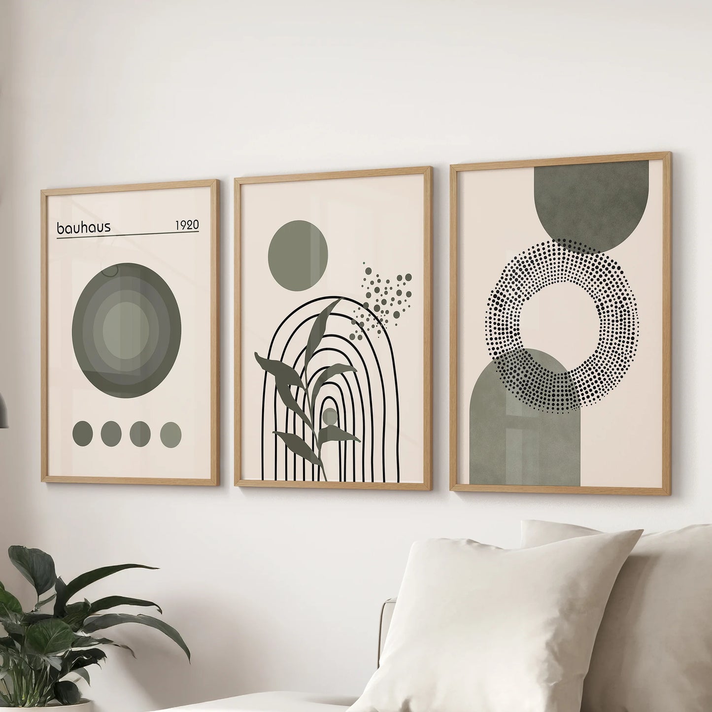 Mid-century modern abstract shapes, three prints in slim wood frames, create a clean focal wall in the living room over the couch.