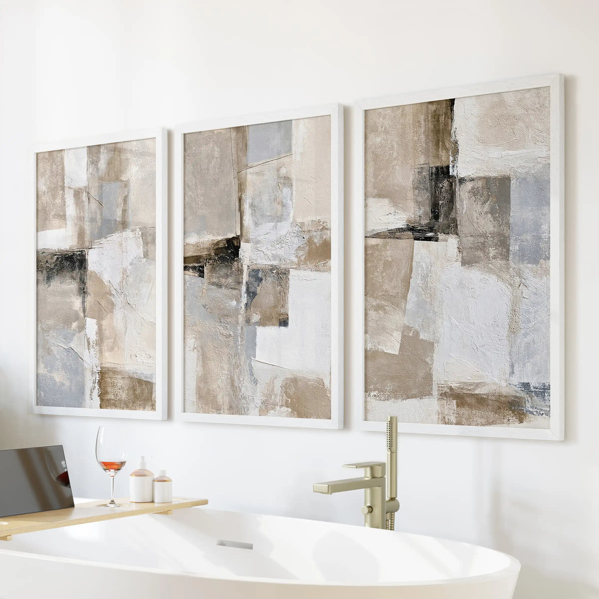 Beige brushstrokes, a three-print wall hanging set, softens the bathroom above the freestanding tub, presented in bright white frames.