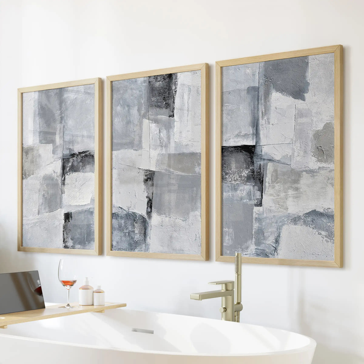 Monochrome minimalist abstracts poster set of 3, in thin wood frames, hangs above the soaking tub to bring warmth to the clean, modern bath.