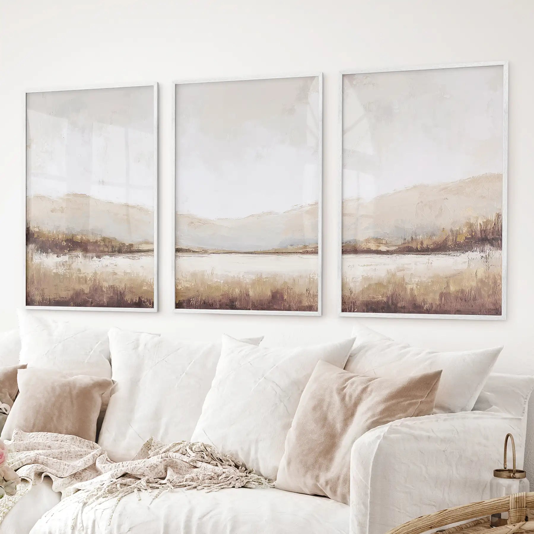 Beige and brown abstract mountain landscape wall art set. White frames above the sofa.