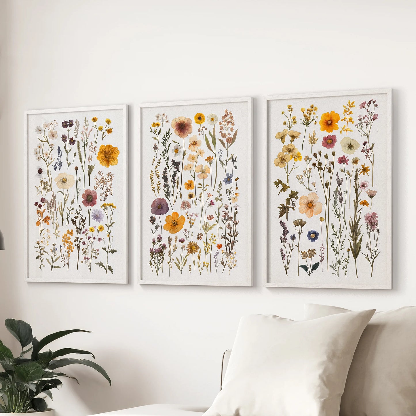 Wall art trio of watercolor wildflowers in white frames floats above the couch, giving the lounge an airy splash of color.