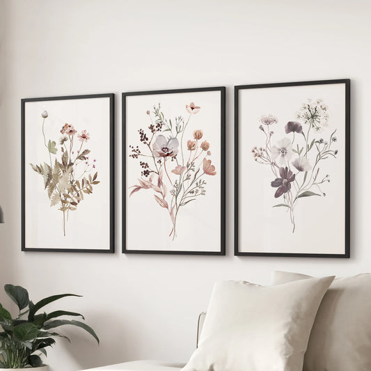 A plant gallery wall set of three meadow-flower art prints in slim black frames forms a graceful display over the couch in the sitting room.
