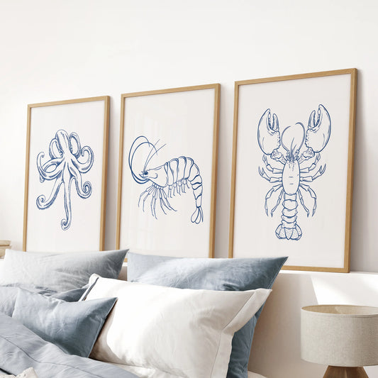Blue octopus prints, a poster trio set in wood-framed artwork for a blue bedroom, positioned above the headboard to anchor the space.