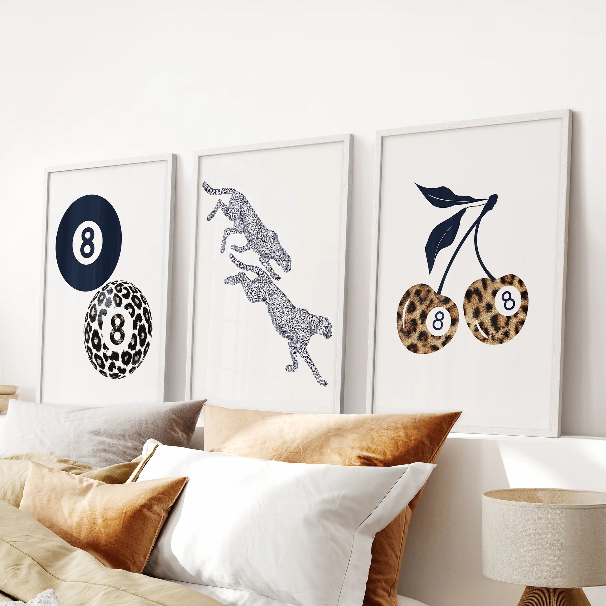 Y2K girly blue wall art, a trio of navy-tinted prints in white frames, creates a polished focal point in the bedroom above the bed.