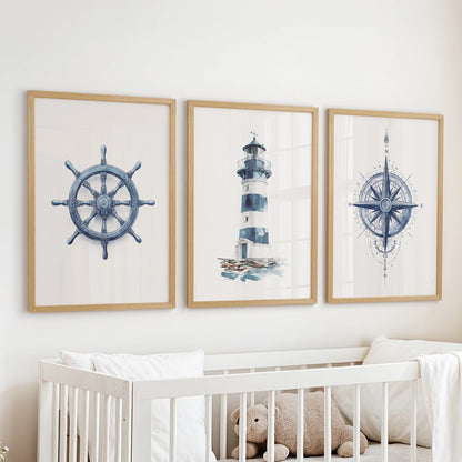 Three nautical wall art prints in natural wood frames cast a gentle navy glow in the nursery, hanging over the bassinet.