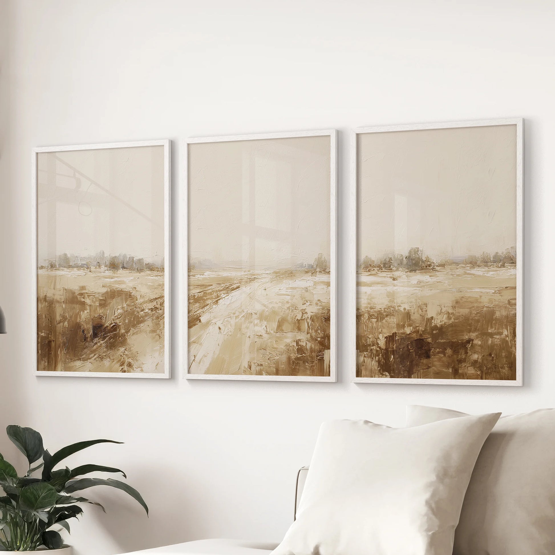 Cottagecore countryside wall art, a set of 3 white-framed posters, brings a breezy note to the lounge when displayed behind the sofa.