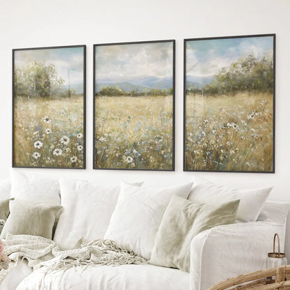 Farmhouse style wall art featuring meadow scene with soft colors. Black frames above the sofa.