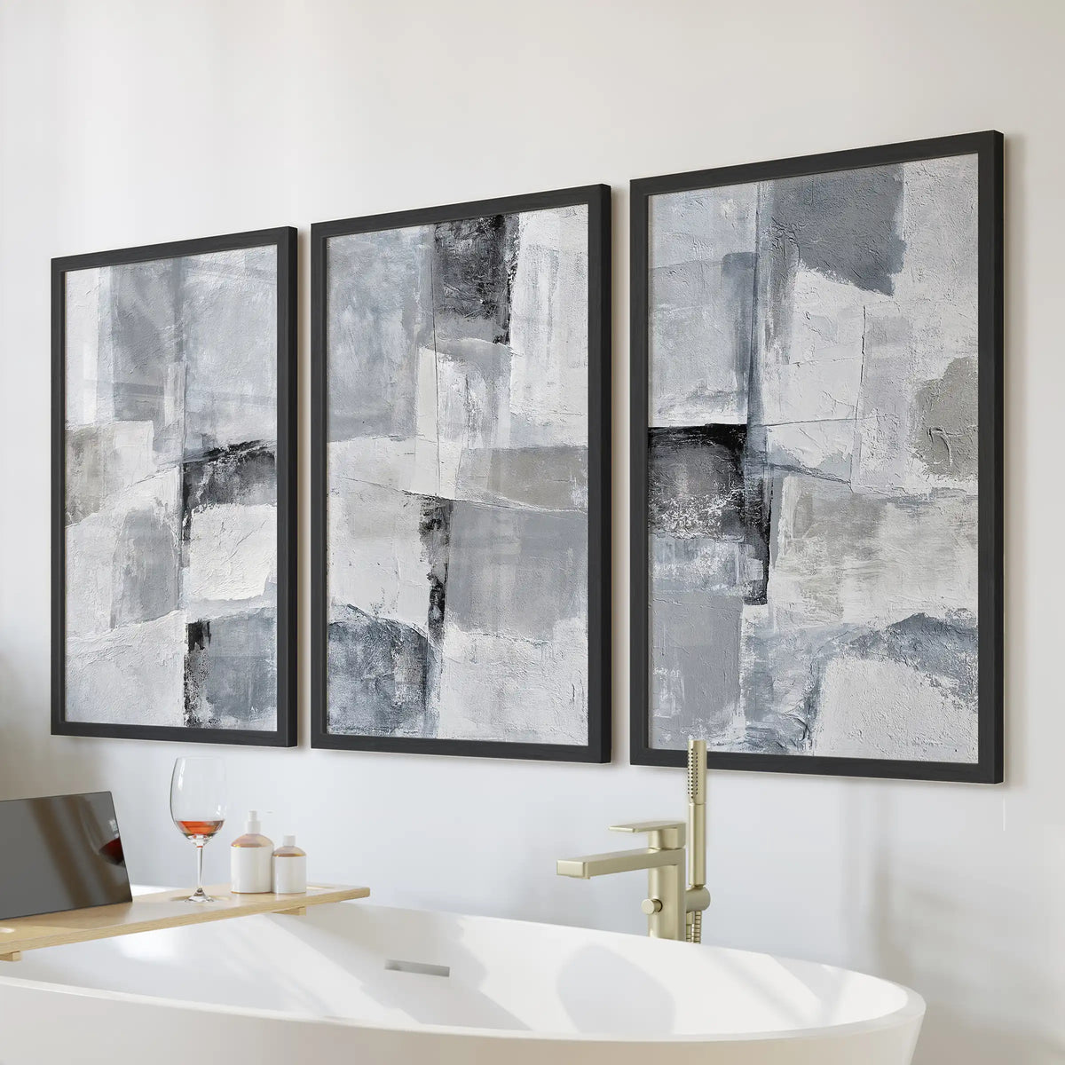 Gray abstract textures wall art set of three, in black framed prints hung over the bathtub wall to bring a calm, modern note to the bathroom.
