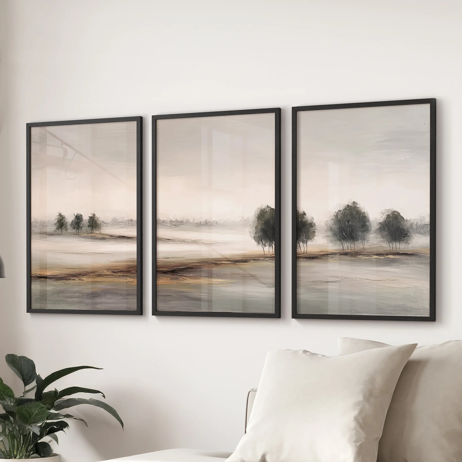 Set of three Nordic artwork prints in slim black frames sits behind the sofa, bringing quiet texture and ease to the family room.