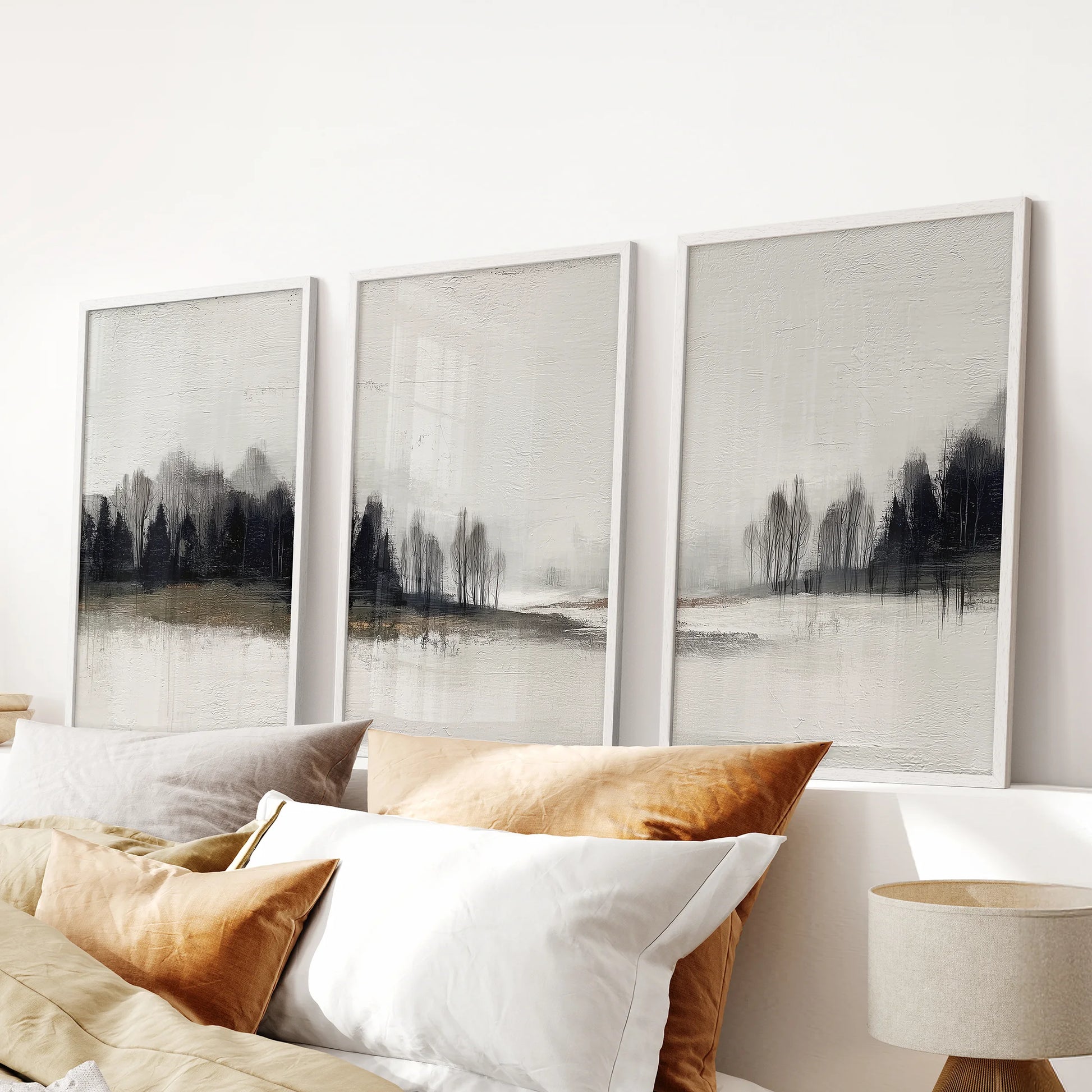 Minimalist neutral nature scenes, a trio of framed wall art with crisp white frames, centered above the bed to lighten the bedroom.