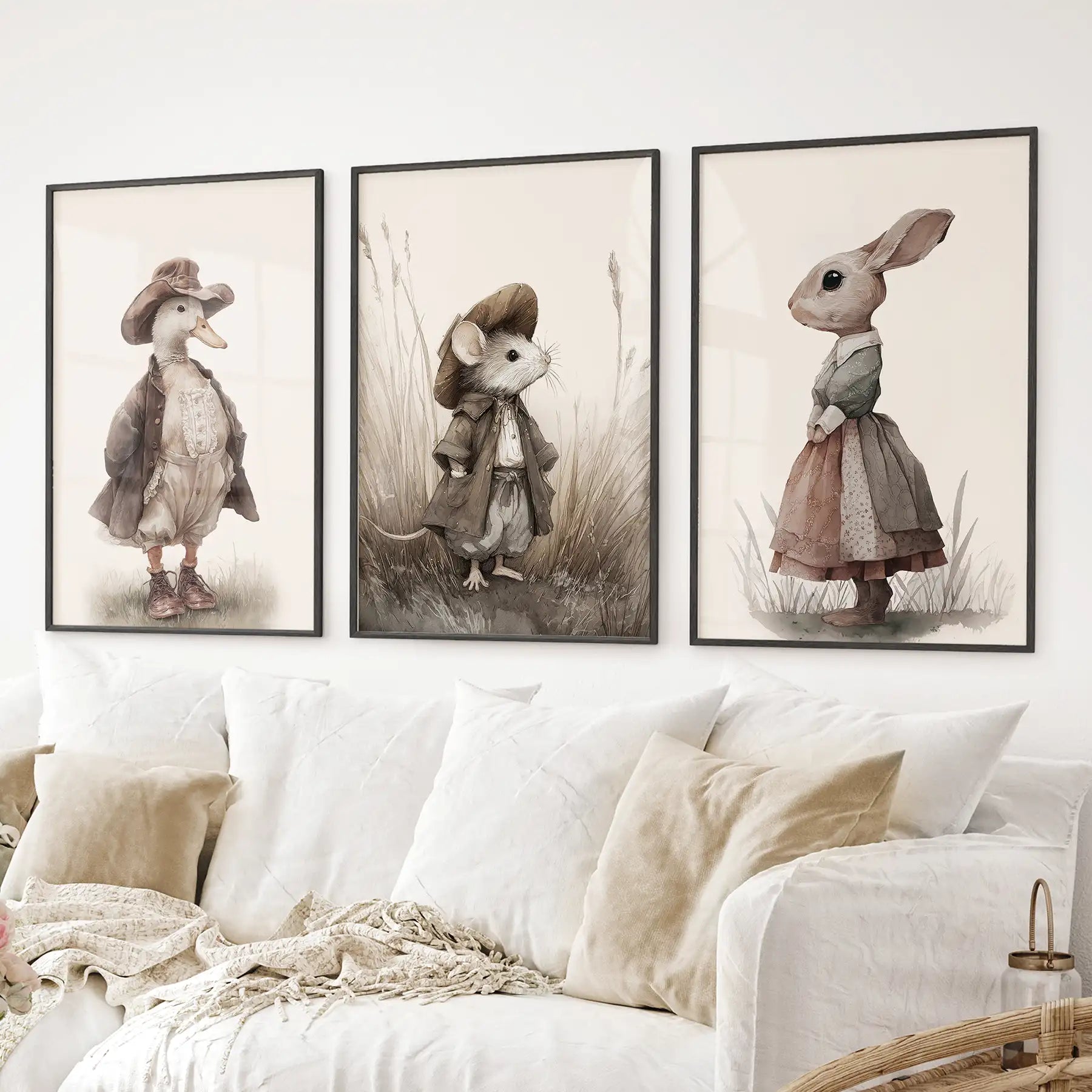 Rustic woodland animal prints duck, mouse, and rabbit in old fashioned clothes. Black frames above the sofa.