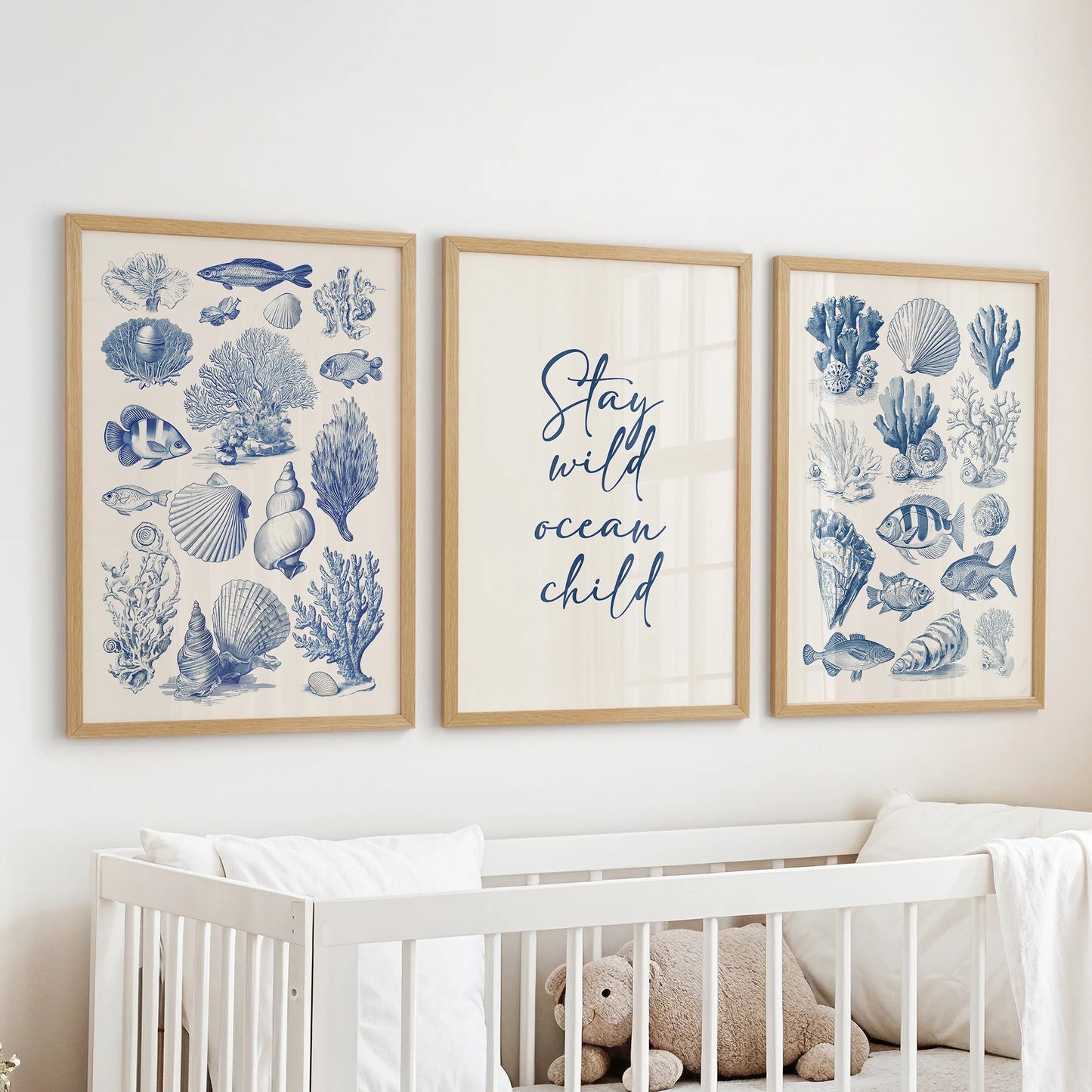 Oak-framed ocean creatures gallery wall trio graces the baby room above the cot with gentle under-the-sea charm.