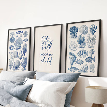 Large ocean typography poster wall art set of three in black frames adds subtle depth and movement above the blue bedroom headboard.