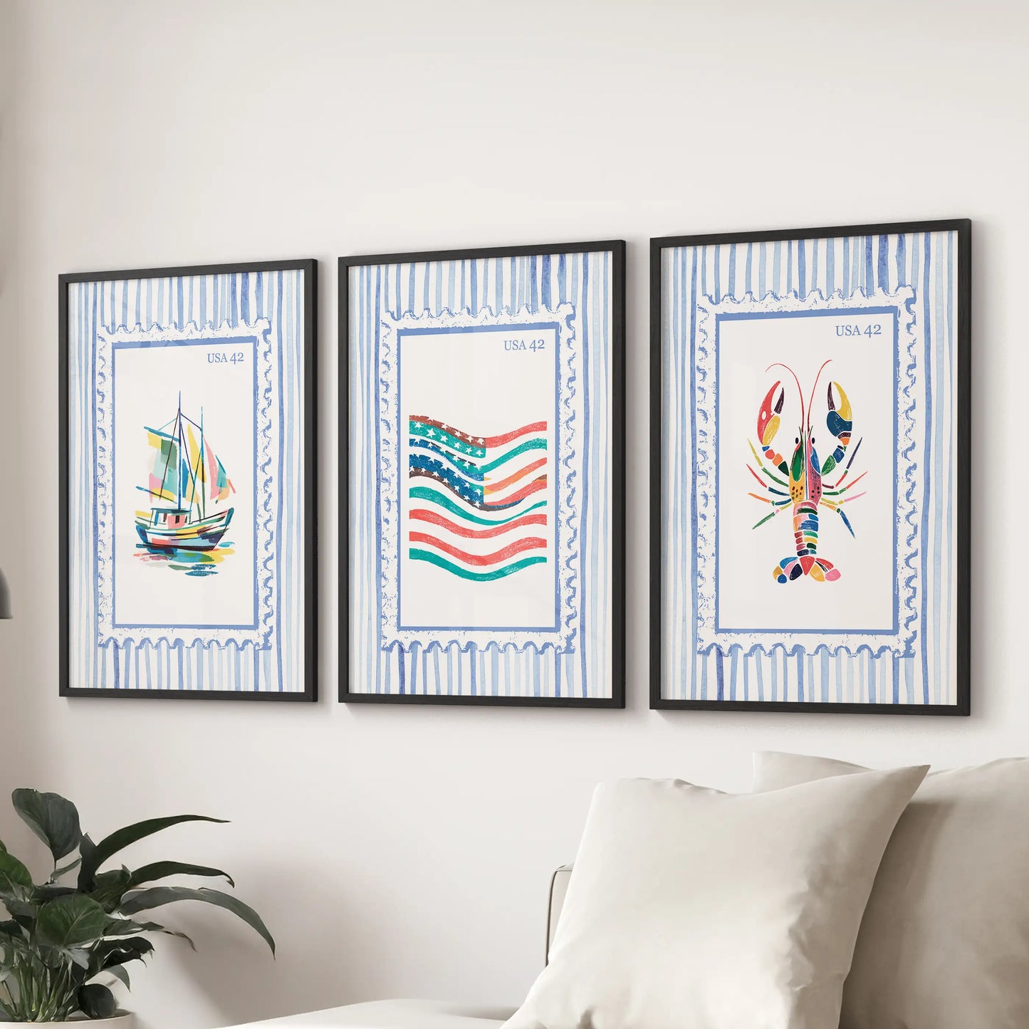 A trio of fisherman-inspired poster prints with matte black frames rests above the couch, adding a crisp coastal accent to the living room.