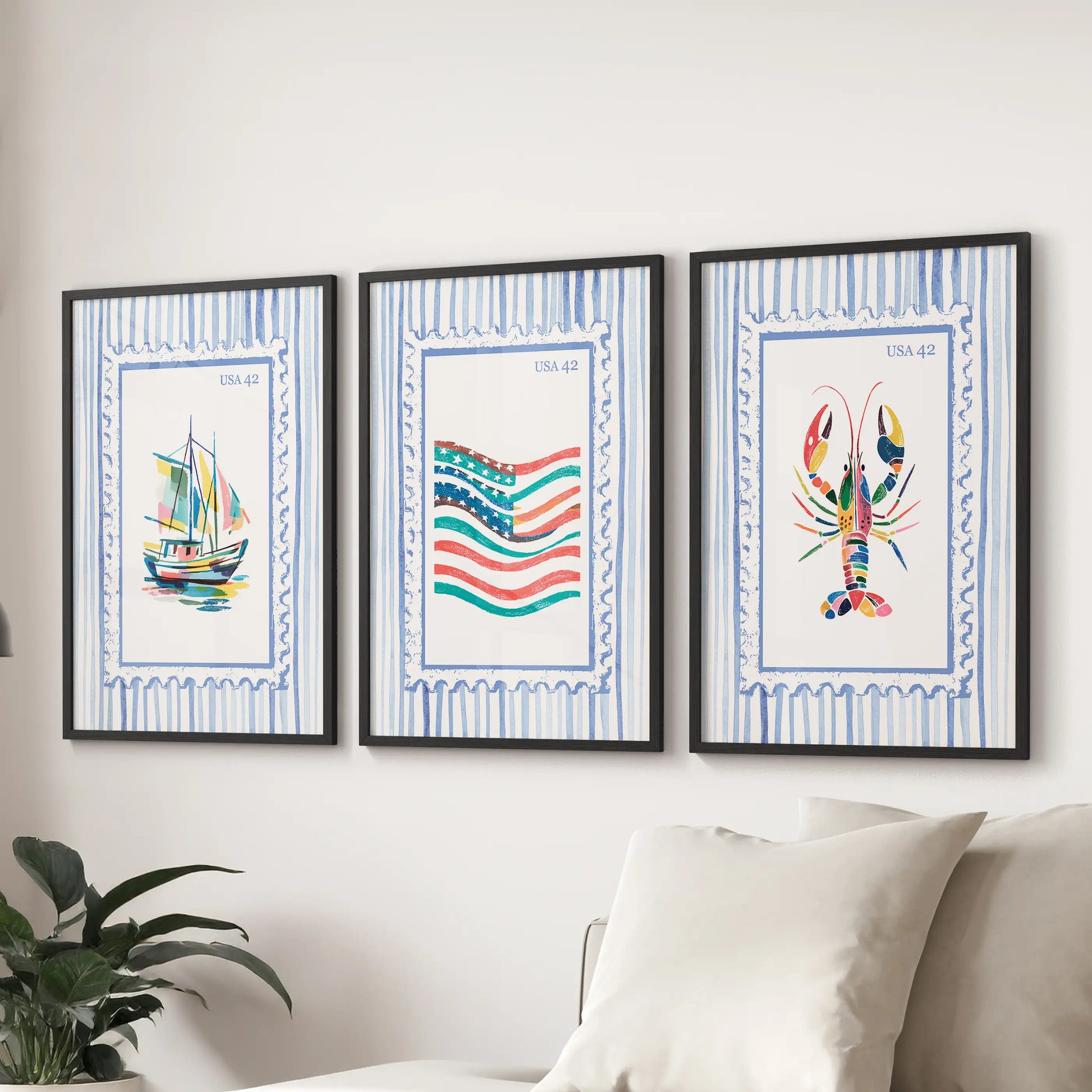 A trio of fisherman-inspired poster prints with matte black frames rests above the couch, adding a crisp coastal accent to the living room.