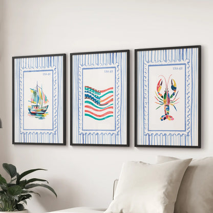 A trio of fisherman-inspired poster prints with matte black frames rests above the couch, adding a crisp coastal accent to the living room.