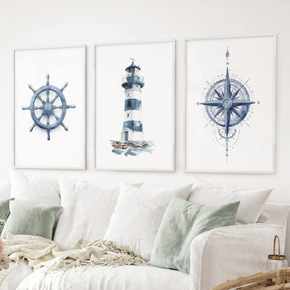 3 piece maritime wall art featuring watercolor prints of a ship wheel, striped lighthouse, and detailed compass rose in navy blue tones. White frames above the sofa.