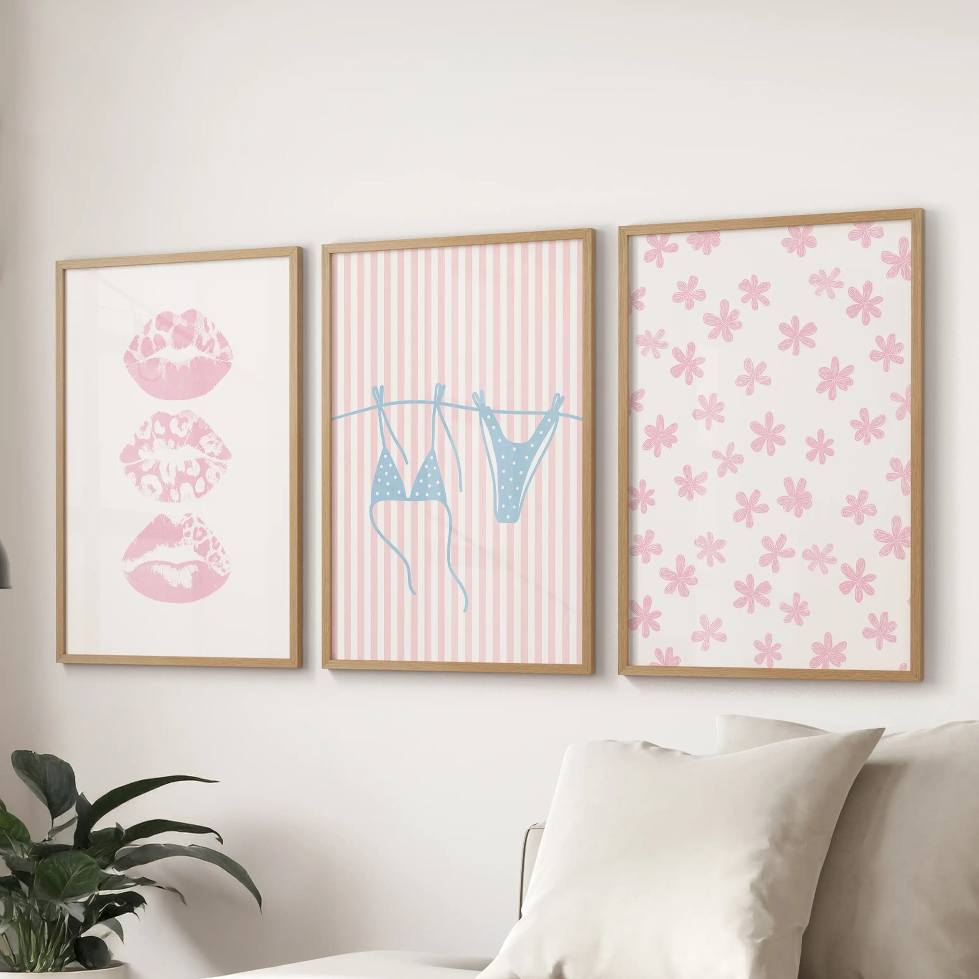 Set of three coquette beach pictures in warm wood frames spans the wall behind the couch, creating an inviting coastal accent.