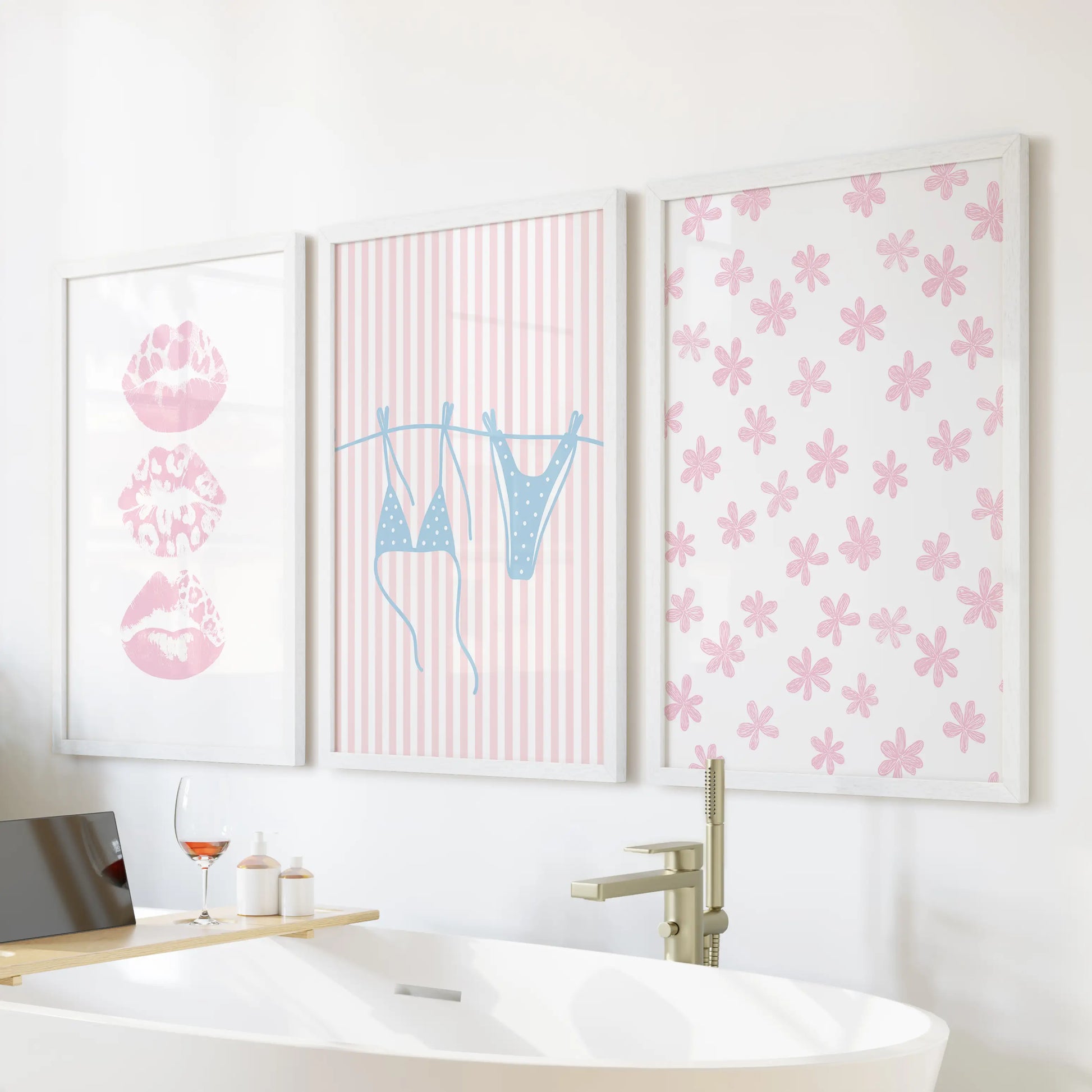 Preppy seaside prints, a three-piece wall art set, sit above the soaking tub in bright white frames to lighten a serene bathroom space.