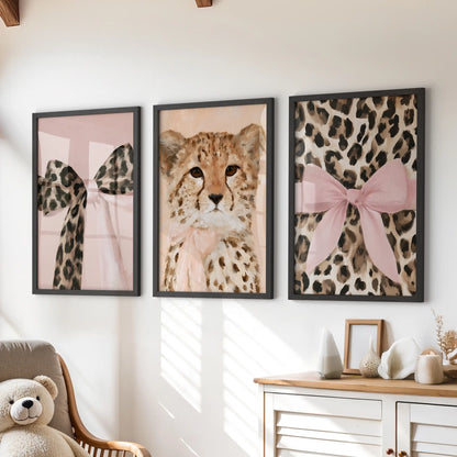 A three-piece wall art trio of cheetah and leopard images in black frames forms a playful, tidy row above the playroom dresser.