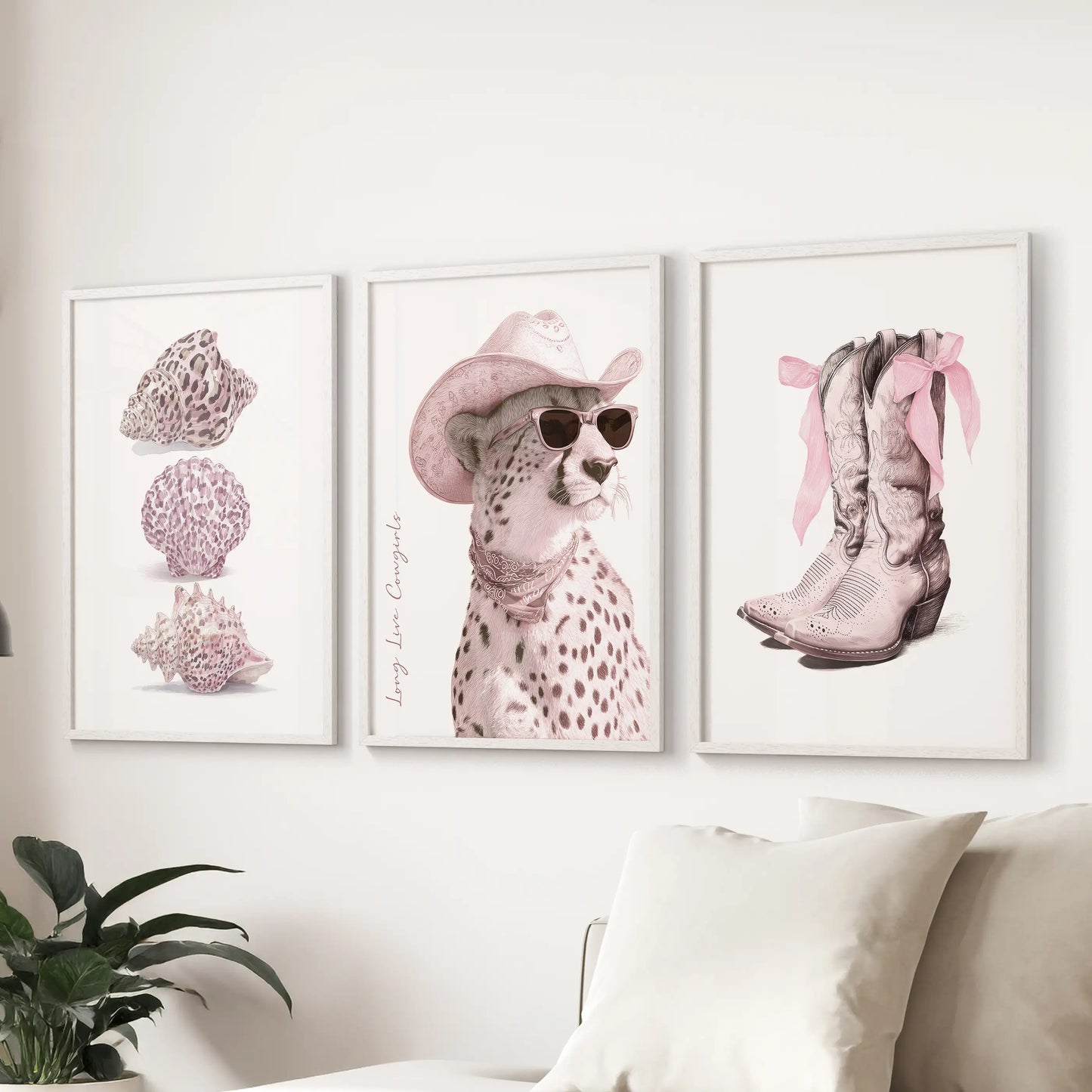 White-framed pink leopard art prints, arranged as a three-piece set, rest above a sofa to balance lively spots with airy calm in the sitting room.