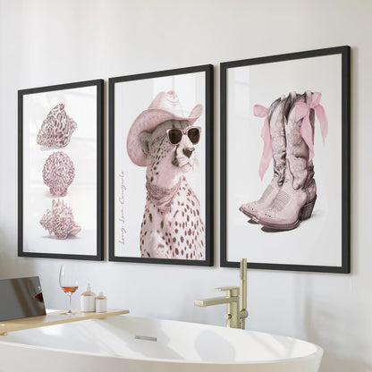 Pink cheetah three-print wall art set in black frames hangs over the tub, giving a bathroom a coquette pop with rosy spots and clean, modern lines.
