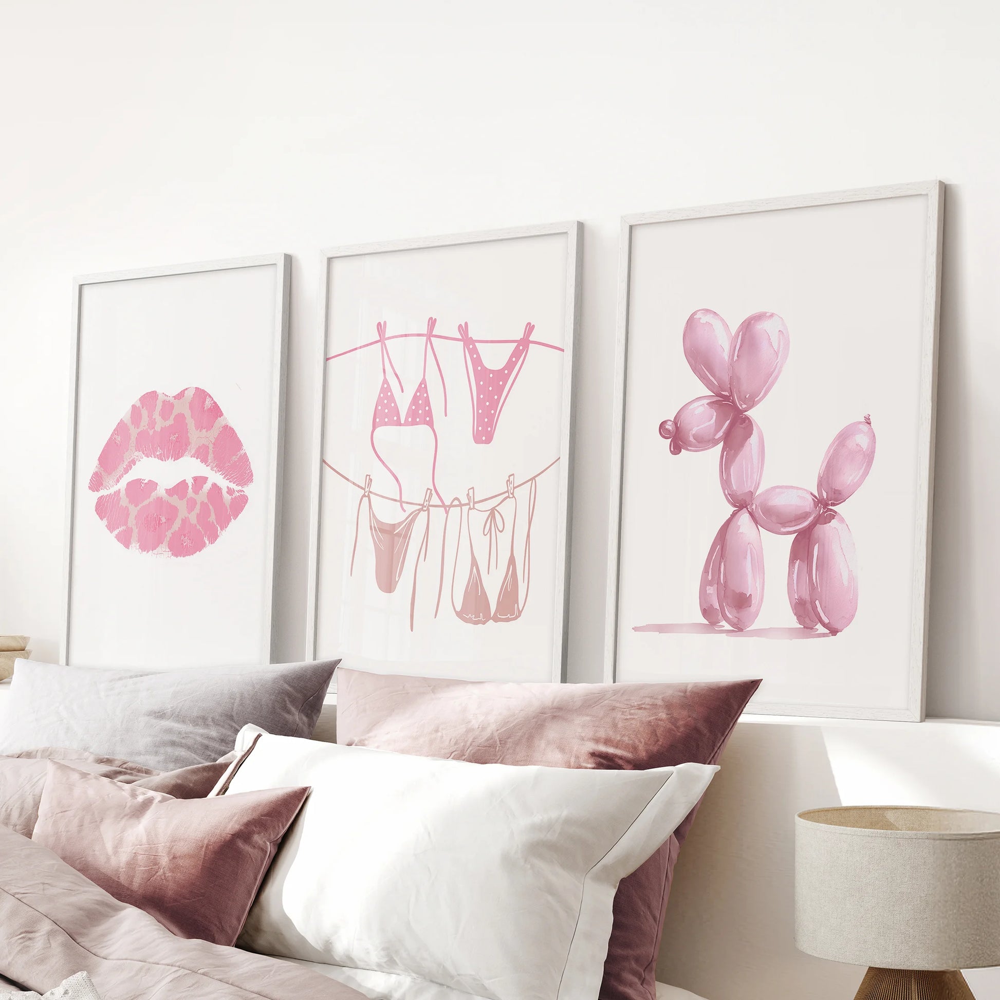 Balloon dog wall art, set of three, brings a wink of fun to the pink bedroom; white frames grouped above the bed headboard keep it neat and chic.