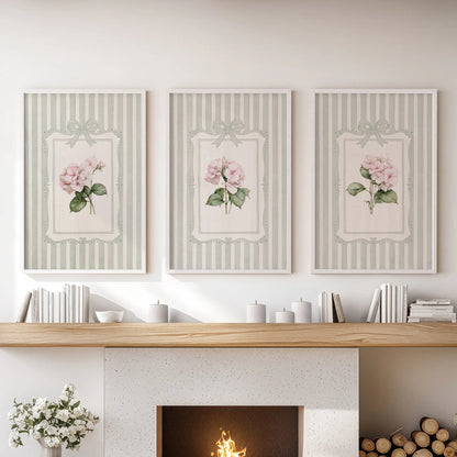 Three-piece wall art set featuring pink hydrangea blooms in white frames above a lounge fireplace mantel.