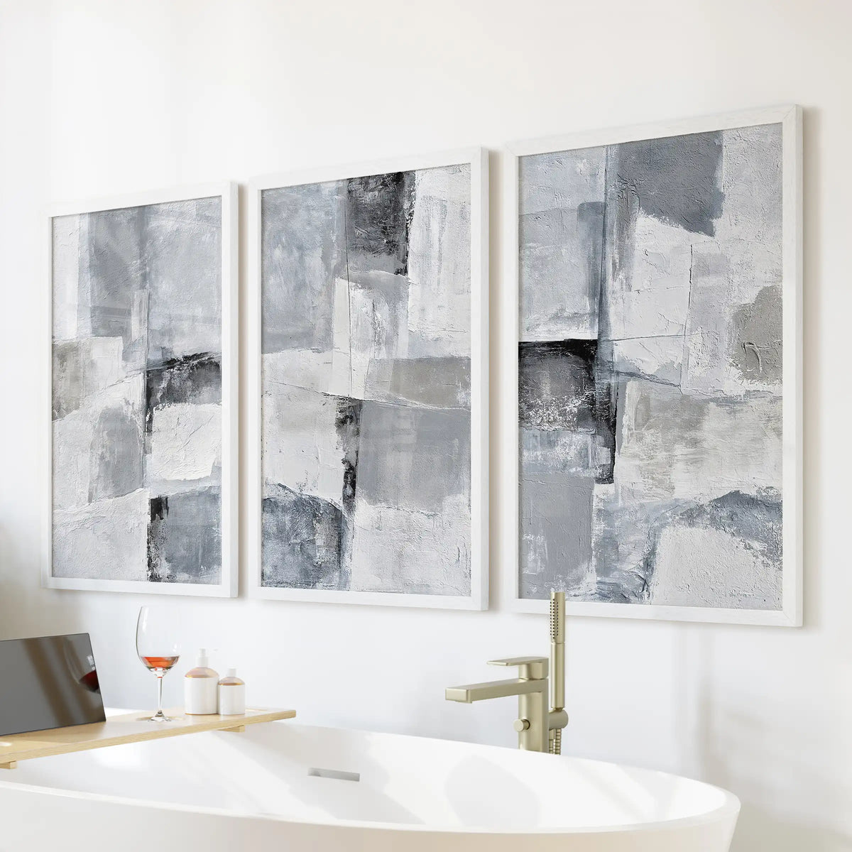 Organic modern shapes large wall art set of 3, finished in white frames, hangs over the tub wall to lend the bathroom a light, spa-like calm.